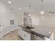 Kitchen island featuring a stainless steel sink, granite countertops, and modern pendant lighting at 3903 E French Trotter St, San Tan Valley, AZ 85140