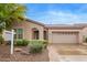 Charming home featuring a two-car garage, desert landscaping, and inviting arched entryway at 4121 E Narrowleaf Dr, Gilbert, AZ 85298