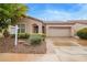 Charming home featuring a two-car garage, desert landscaping, and inviting arched entryway at 4121 E Narrowleaf Dr, Gilbert, AZ 85298