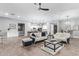 Spacious living room open to the kitchen features modern furniture, fixtures, and finishes at 4121 E Narrowleaf Dr, Gilbert, AZ 85298