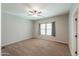 Bedroom featuring a ceiling fan, carpeted floor, window, and access to other rooms at 4135 E Cathy Dr, Gilbert, AZ 85296