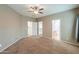 Bedroom with neutral carpet flooring, ceiling fan, and ensuite bathroom at 4135 E Cathy Dr, Gilbert, AZ 85296