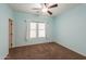 Bedroom with light blue walls, carpeted floor, ceiling fan, and a window at 4135 E Cathy Dr, Gilbert, AZ 85296