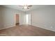 Bedroom with a carpeted floor, ceiling fan, light gray walls, and access to other rooms at 4135 E Cathy Dr, Gilbert, AZ 85296