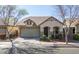 Charming single-story home with a well-manicured front yard and attached two-car garage at 4135 E Cathy Dr, Gilbert, AZ 85296