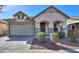 Lovely home featuring stone accents, an arched entryway, and a neat front yard with desert landscaping at 4135 E Cathy Dr, Gilbert, AZ 85296