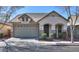 Charming single-story home featuring a two car garage, neutral stucco, and decorative stone accents at 4135 E Cathy Dr, Gilbert, AZ 85296