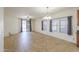 Open concept living room features neutral tile floors, ceiling fan and sliding door to the backyard at 4135 E Cathy Dr, Gilbert, AZ 85296