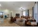 Comfortable living room featuring leather furniture, a ceiling fan, and a decorative rug at 4135 E Cathy Dr, Gilbert, AZ 85296