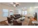 Living room with plush seating, ceiling fans, large windows and neutral carpet at 4135 E Cathy Dr, Gilbert, AZ 85296