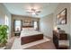 Cozy main bedroom with carpet floors, ceiling fan, modern furniture, and natural light at 4135 E Cathy Dr, Gilbert, AZ 85296