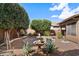 Private backyard with a stone fountain, brick paver patio, desert landscaping and comfortable seating at 44087 W Granite Dr, Maricopa, AZ 85139