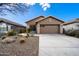 Charming single-story home with desert landscaping and a two-car garage in a sunny setting at 44087 W Granite Dr, Maricopa, AZ 85139