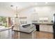 Bright kitchen featuring a breakfast bar, stainless steel sink, and ample cabinet space and backyard views at 44087 W Granite Dr, Maricopa, AZ 85139