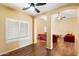 Inviting living room with hardwood floors, white window shutters, and archways to the rest of the home at 44087 W Granite Dr, Maricopa, AZ 85139