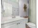 Bathroom features neutral tones, storage shelves and a cabinet at 44961 W Miraflores St, Maricopa, AZ 85139