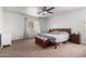 Spacious bedroom with natural light, a ceiling fan, and neutral-toned carpet and paint at 44961 W Miraflores St, Maricopa, AZ 85139