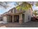 Charming home showcasing a covered entryway with decorative stone pillars and desert landscaping at 44961 W Miraflores St, Maricopa, AZ 85139