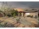 Evening backyard with desert landscaping, stone pathways, and private patio, creating a tranquil outdoor oasis at 4533 E Coyote Wash Dr, Cave Creek, AZ 85331