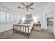 Brightly lit main bedroom features a wooden bed frame and plenty of natural light from the windows at 4533 E Coyote Wash Dr, Cave Creek, AZ 85331