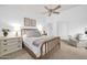 Bright main bedroom with a wooden bed frame, dresser, chair, and ceiling fan at 4533 E Coyote Wash Dr, Cave Creek, AZ 85331