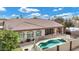 Aerial view of the backyard with a pool, covered patio, fire pit and lush landscaping at 4618 E Carriage Ct, Gilbert, AZ 85297