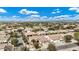 Expansive aerial view of a residential community with well-maintained homes and lush landscaping under a blue, cloudy sky at 4618 E Carriage Ct, Gilbert, AZ 85297