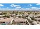 Overhead shot of a residential area highlighting backyards with pools and patios, set against the backdrop of distant mountains at 4618 E Carriage Ct, Gilbert, AZ 85297