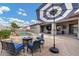 Backyard seating area with umbrella, fire pit, and partial view of the pool and residence at 4618 E Carriage Ct, Gilbert, AZ 85297