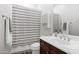 Functional bathroom includes a shower with a striped curtain and ample lighting at 4618 E Carriage Ct, Gilbert, AZ 85297