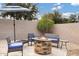 Outdoor fire pit area with comfortable seating and a shade umbrella at 4618 E Carriage Ct, Gilbert, AZ 85297