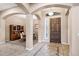 Grand foyer features tile flooring, soaring archways, and a wooden front door with sidelight windows at 4618 E Carriage Ct, Gilbert, AZ 85297