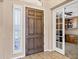 View of front door opening to an office space with natural light and a window with shutters at 4618 E Carriage Ct, Gilbert, AZ 85297