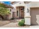 Inviting front entrance with a solid wood door, stone accents, and a well-manicured landscape at 4618 E Carriage Ct, Gilbert, AZ 85297