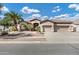 Charming single-story home featuring a tile roof, well-manicured landscaping, and a three-car garage at 4618 E Carriage Ct, Gilbert, AZ 85297