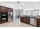 Gourmet kitchen features stainless appliances, granite countertops, and seamless flow to the breakfast area at 4618 E Carriage Ct, Gilbert, AZ 85297