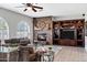 Cozy living room featuring a stone fireplace, custom built-ins, and plenty of space for Gathering and guests at 4618 E Carriage Ct, Gilbert, AZ 85297