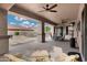 Covered patio with ceiling fans, stone pavers, and wicker furniture offers a relaxing outdoor space at 4618 E Carriage Ct, Gilbert, AZ 85297