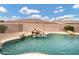 Backyard pool with rock waterfall feature and surrounding gravel at 4618 E Carriage Ct, Gilbert, AZ 85297