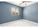 A cozy bedroom with a window and tile floors at 5115 W Surrey Ave, Glendale, AZ 85304