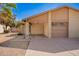 View of the home's desert landscaping, well-manicured yard, and a spacious driveway to the garage at 5115 W Surrey Ave, Glendale, AZ 85304