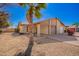 Home with desert landscaping, a lush palm tree, and a view of the car port at 5115 W Surrey Ave, Glendale, AZ 85304