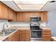 A close-up view of a kitchen featuring stainless steel appliances and light wood cabinets at 5115 W Surrey Ave, Glendale, AZ 85304