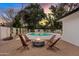 Relaxing backyard with a fire pit, seating, and a sparkling pool, ideal for entertaining and enjoying outdoor evenings at 5819 E Ludlow Dr, Scottsdale, AZ 85254