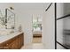 Bright bathroom boasts a stylish vanity and modern glass door leading to the bedroom at 5819 E Ludlow Dr, Scottsdale, AZ 85254