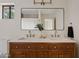 Bathroom with double sink vanity, large mirror, quartz countertop, and wooden cabinets at 5819 E Ludlow Dr, Scottsdale, AZ 85254