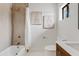 Bright bathroom featuring a bathtub with stylish tile surround, modern vanity, and decorative wall art at 5819 E Ludlow Dr, Scottsdale, AZ 85254