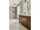 Beautiful primary bath features a step-in shower with glass surround, mosaic tile accent wall, and floating vanity at 5819 E Ludlow Dr, Scottsdale, AZ 85254