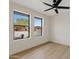 Bright and airy bedroom featuring wood floors, neutral paint, and an updated ceiling fan at 5819 E Ludlow Dr, Scottsdale, AZ 85254