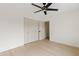 This bedroom features a ceiling fan, wood floors, neutral paint, and double closets at 5819 E Ludlow Dr, Scottsdale, AZ 85254